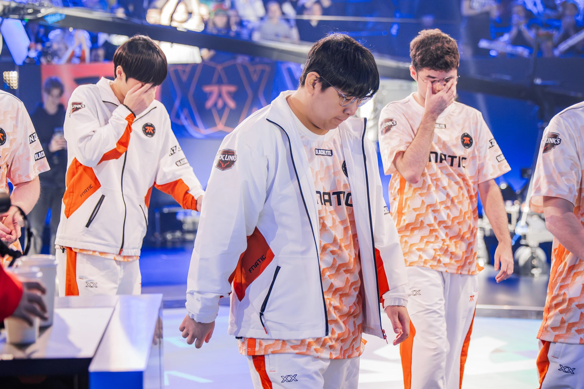 Fnatic players walking off stage after being eliminated. Image via Riot Games<br>